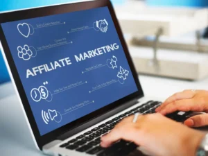 A person typing on a laptop displaying an Affiliate Marketing infographic, highlighting strategies for successful online marketing.