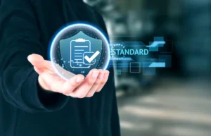 A hand holds a glowing orb displaying a clipboard with a checkmark, symbolizing compliance and quality standards in digital form.